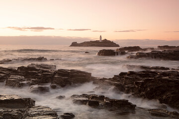 Sunset along the rocky coast near Godrevy Lighthouse, Cornwall. 