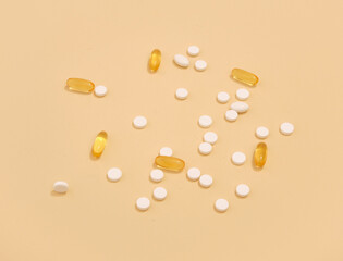 White tablets and yellow capsules to cure diseases. Medicine concept.