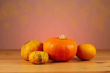 Obraz na płótnie Canvas Autumn still life with pumpkins on wooden table and bokeh background