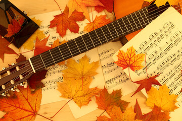 metronome, music paper, autumn leaves and guitar - 672642395