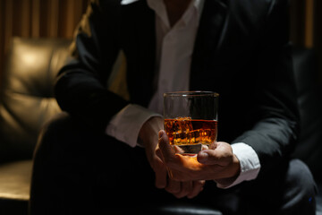 businessmen holding a glass of whiskey