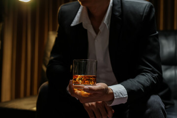 businessmen holding a glass of whiskey