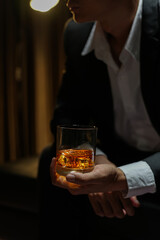 businessmen holding a glass of whiskey