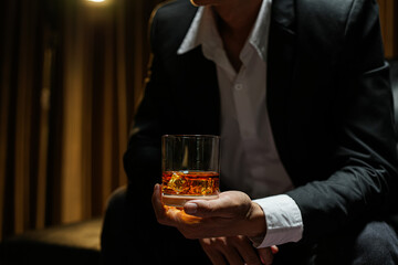 businessmen holding a glass of whiskey