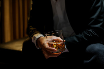 businessmen holding a glass of whiskey