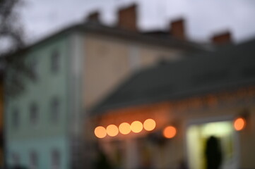 evening city street in the light of headlights and lanterns blur background