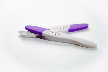 Two positive pregnancy tests on a white background. Close-up, macro, there is space for copying.