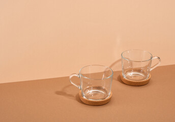 Two glass cups in coasters stand on the table. Copy space for text. Tea friendly party.