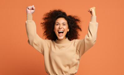 
Photo of cheerful overjoyed funny woman raise fists in victory see big bargains in phone isolated...