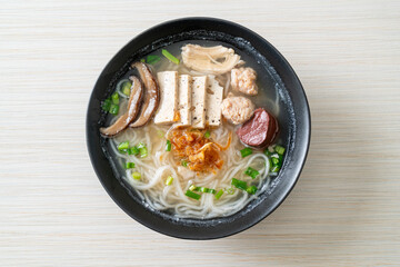 Vietnamese Rice Noodles Soup with Vietnamese Sausage served vegetables and crispy onion