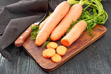 Carrots fresh on dark board