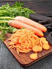Carrots grated on wooden board