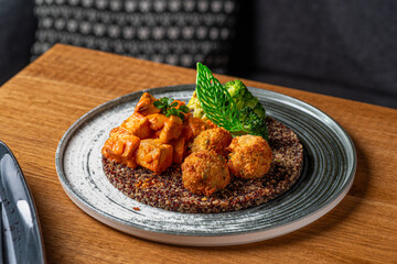 Buddha bowl with quinoa, broccoli and mushroom tofu sauce. Healthy eating