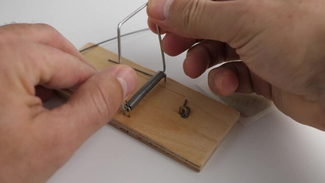 A person sets a trap in a mousetrap in the form of a narcotic potion. The concept of drug addiction.