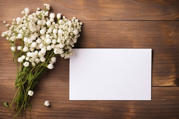 Obraz na płótnie Canvas White gypsophila flowers and envelope on brown wooden background.