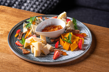 Cheese plate served with nuts and honey