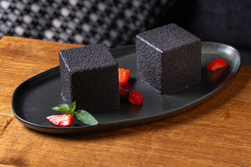 Obraz na płótnie Canvas French mousse cake covered with dark chocolate icing. Modern European dessert