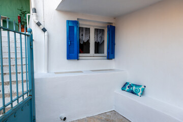 A Mediterranean style architecture with an area built in the structure as an outdoor table and chair.