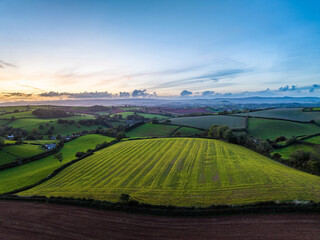Sunset over Fields and Farms from a drone, Torquay, Devon, England, Europe