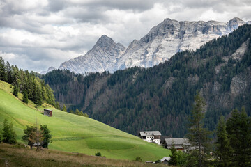beautiful panoramic landscape of rural village in alta badia south tyrol with cloudy mountains...