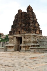 Hampi, Karnataka India - July 24 2023: Stone chariot at temple of Vijaya Vittala complex in desert valley of Hampi