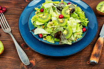 Green salad of kiwi and lettuce.