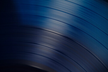 Sound tracks on a vinyl blue record closeup macro photo.
