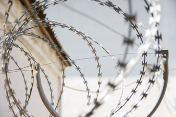 view of the sky through barbed wire on a sunny day. selective focus .