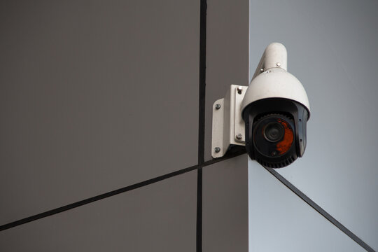 outdoor surveillance camera installed on the corner of a modern building. High quality photo