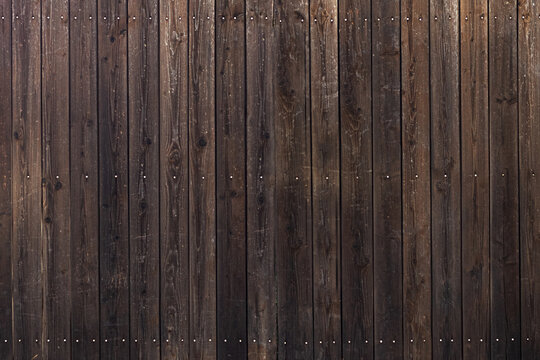 Wooden fence made of boards. Wood texture background, wooden planks