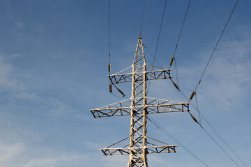 high voltage power lines against the background of blue sky. selective focus .