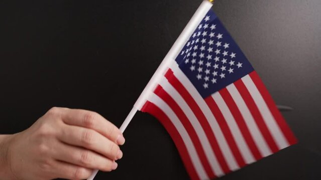 hand waving a flag of USA on the background of a school board, foreign English american language school, education and training, online courses
