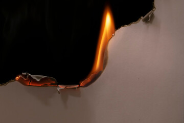 burning paper, glowing edge of paper on a black background