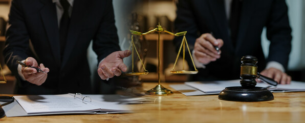 Partner lawyers or attorneys discussing a contract agreement. Successful businessmen have a contract in place to protect it,signing of modest agreements form in office...