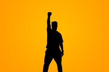 silhouette of a person with an arm raised