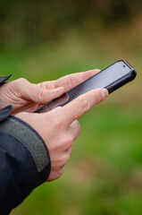 a man's hands using his smartphone