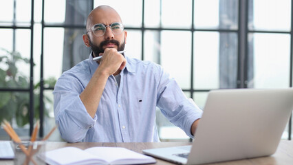 Businessman working on the table with laptop in a new office