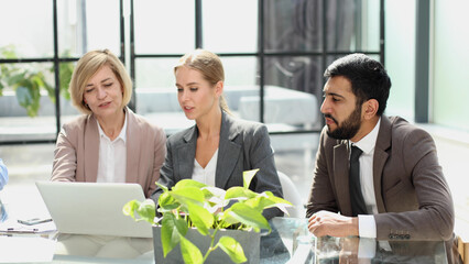 Portrait of creative business team using laptop