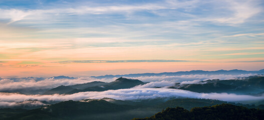 Mountain fog valley during sunrise.The background of nature with fog on the mountain, In the rainy weather in the countryside