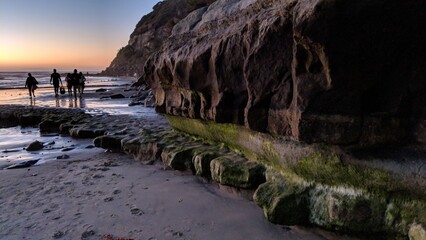 Southern California beach scenes with sunsets, surfers, tide pools and palms trees at Swamis Reef Surf Park Encinitas California.

