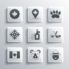 Set Bear head, Canadian ranger hat, Ice hockey sticks, Syrup with pancakes, Flag of Canada, Snowflake, maple leaf and paw footprint icon. Vector