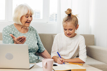 Video education sofa bonding child grandmother togetherness laptop hugging smiling selfie call family granddaughter