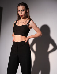 blonde girl moderately posing on a white background