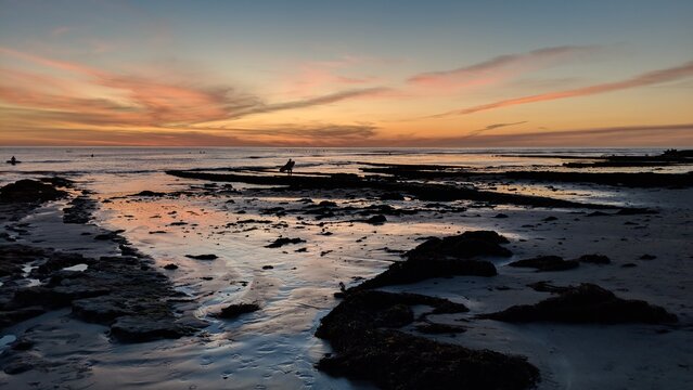 Southern California beach scenes with sunsets, surfers, tide pools and palms trees at Swamis Reef Surf Park Encinitas California.

