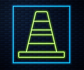 Glowing neon line Traffic cone icon isolated on brick wall background. Vector