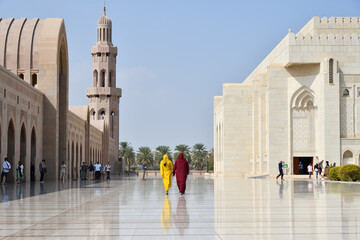 Two women walking in Sultan Qaboos Mosque, Muscat, Oman