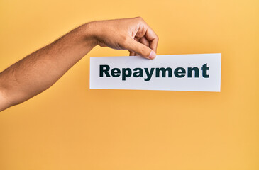 Hand of caucasian man holding paper with repayment word over isolated white background