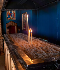 Burning candles inside a Greek monastery.