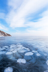 Winter landscape of frozen Baikal Lake in cold winter day. Natural seasonal background with ice...