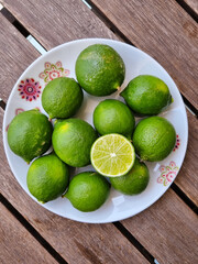 lemons on a plate on a wooden table
